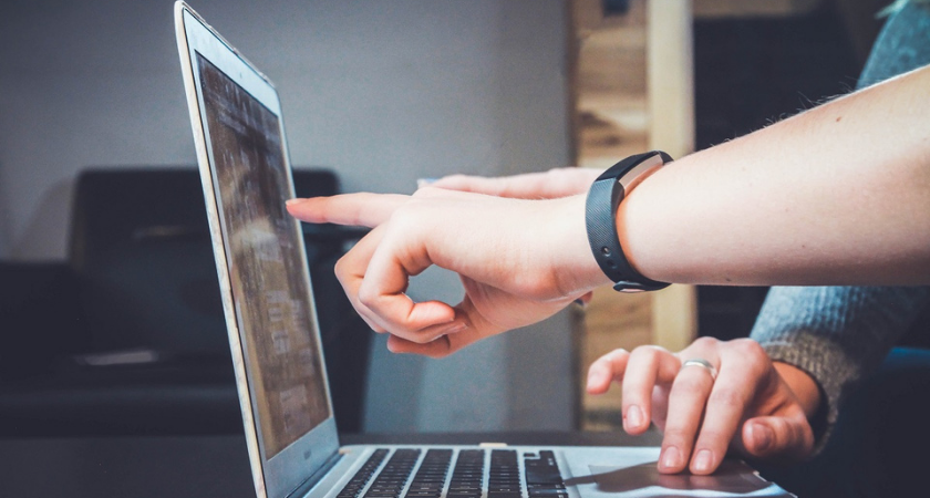 people pointing at a laptop screen